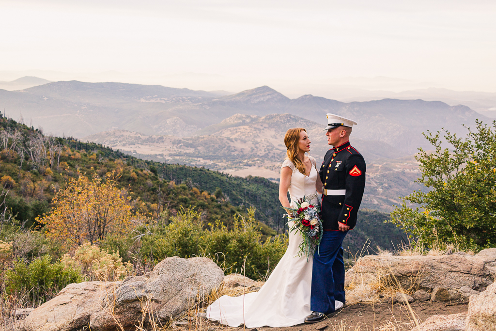 eloping military couple having adventurously eloping at the top of a mountain