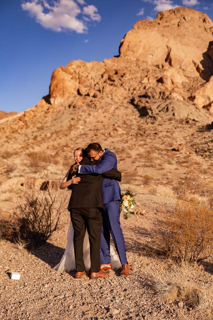 las vegas eloping couple hugging their only friend in attendance