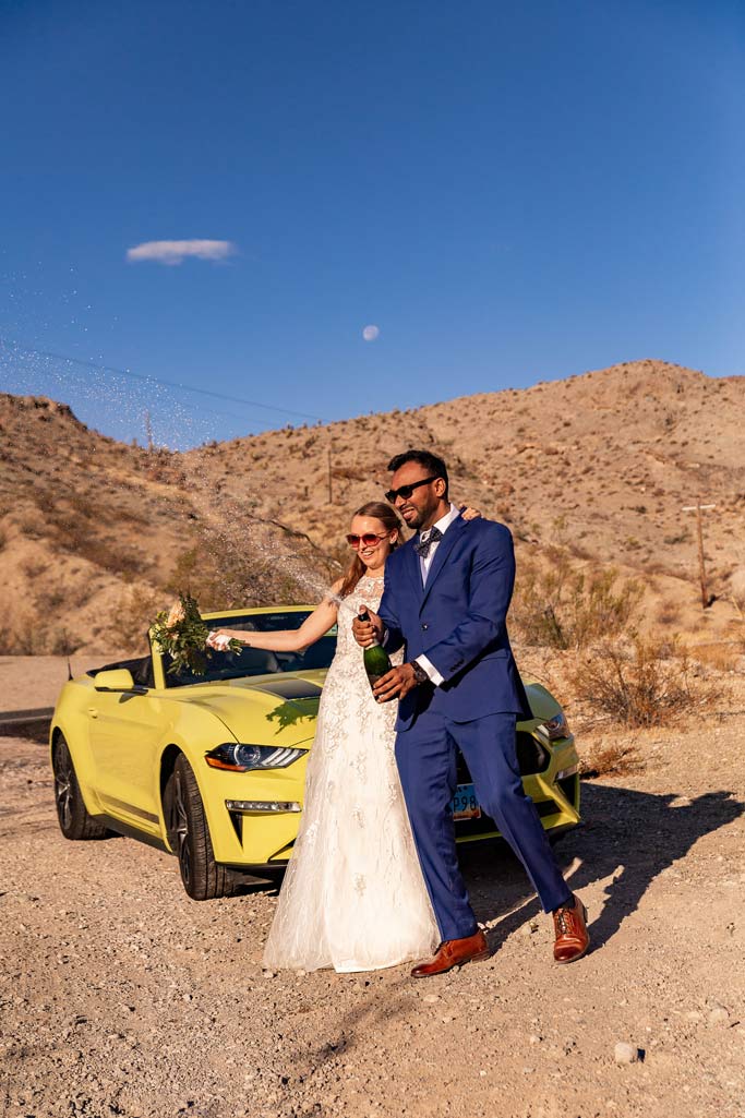 las vegas eloping couple popping champagne